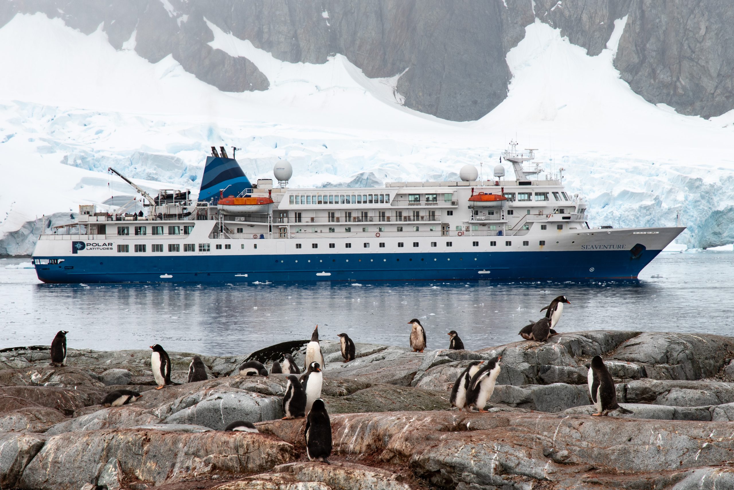 Seaventure ship in Antarctica with penguins in foreground