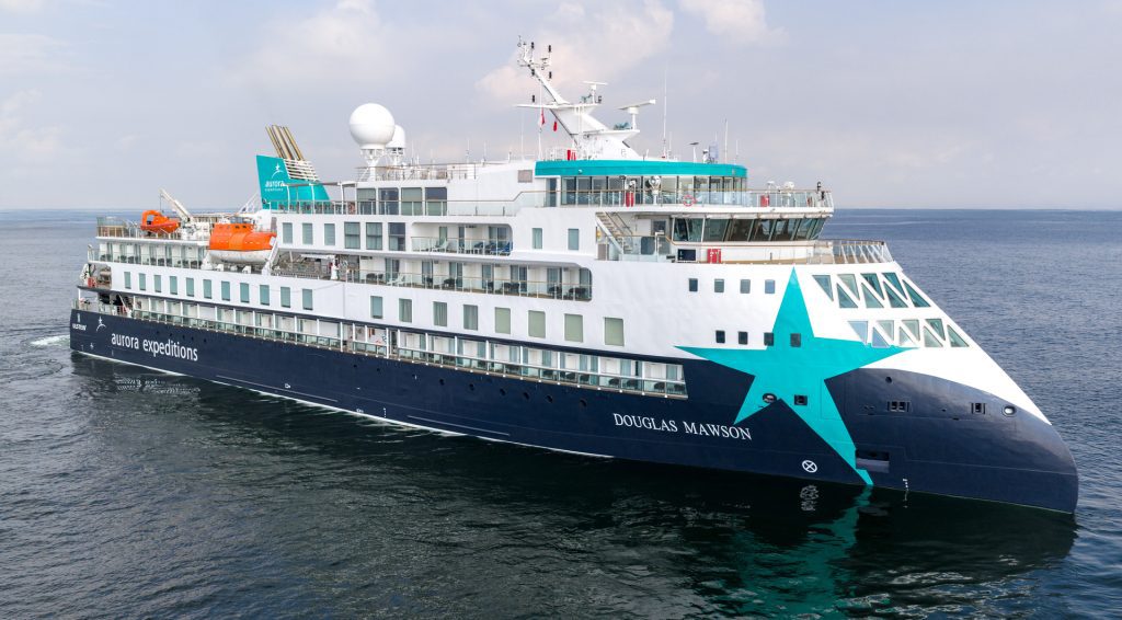 The ship Douglas Mawson sailing on the open ocean.