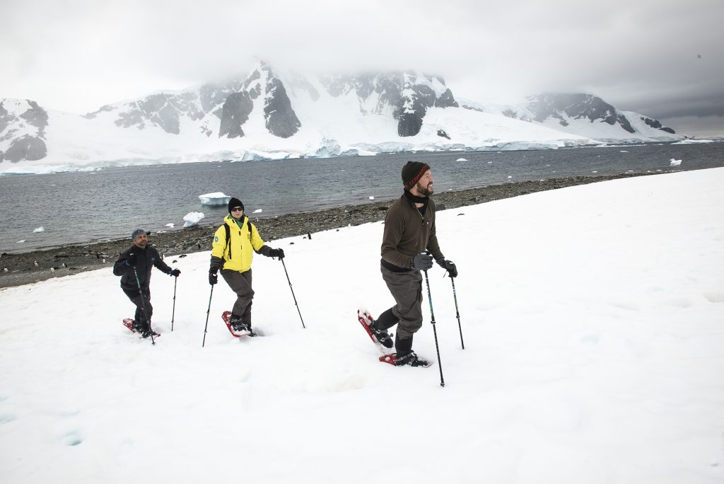 Three guests snowshoeing.