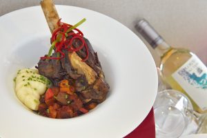 Plate of food with bottle of wine