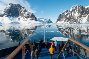 Magellan Explorer bow observation deck with passengers observing the stunning mountain scenery