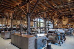 Explorers House lounge with high wooden ceilings and many chairs & tables in Punta Arenas