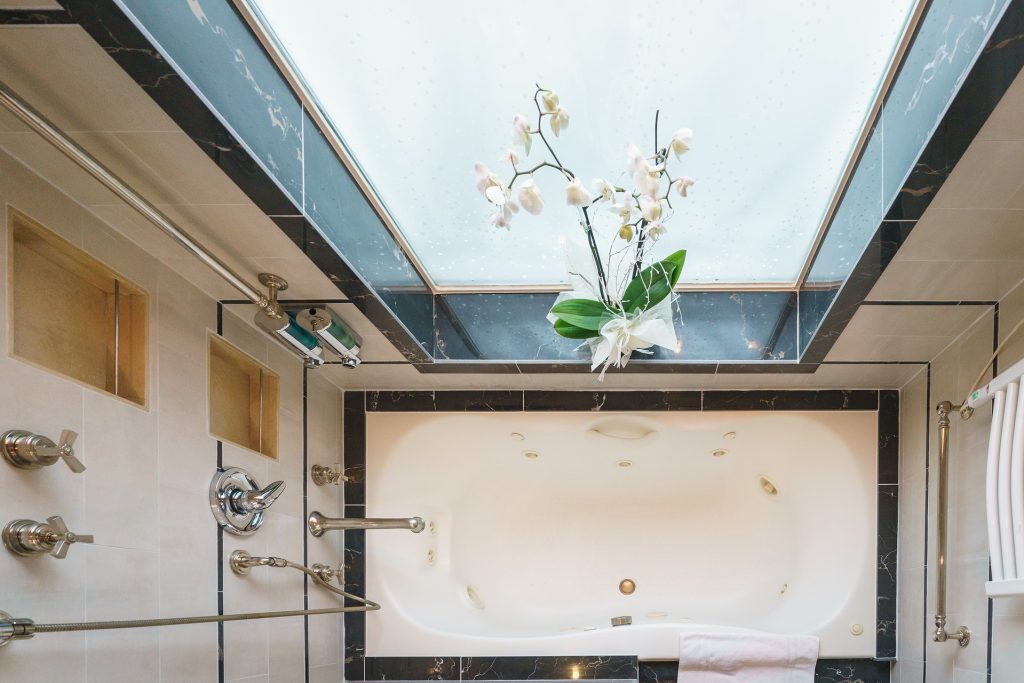 overhead view of bathtub and large window in owner's suite Sea Spirit. 