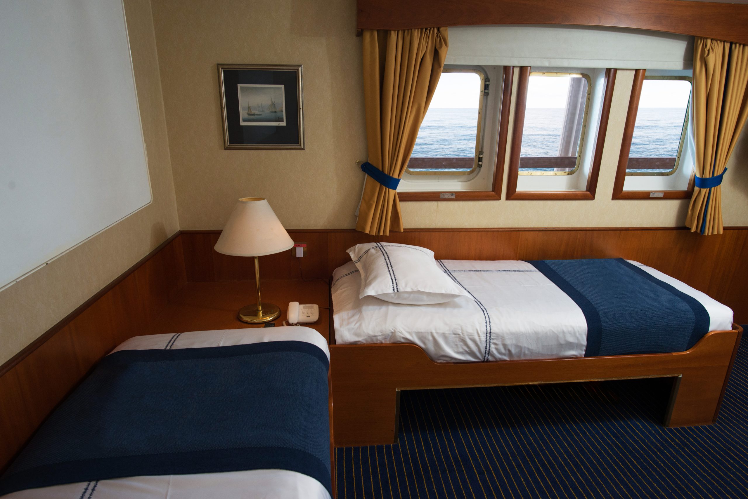 Interior of Superior cabin showing 2 twin beds and 3 windows.