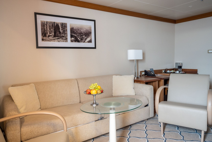 Couch and chair in Grand Suite on Ocean Exploris. 
