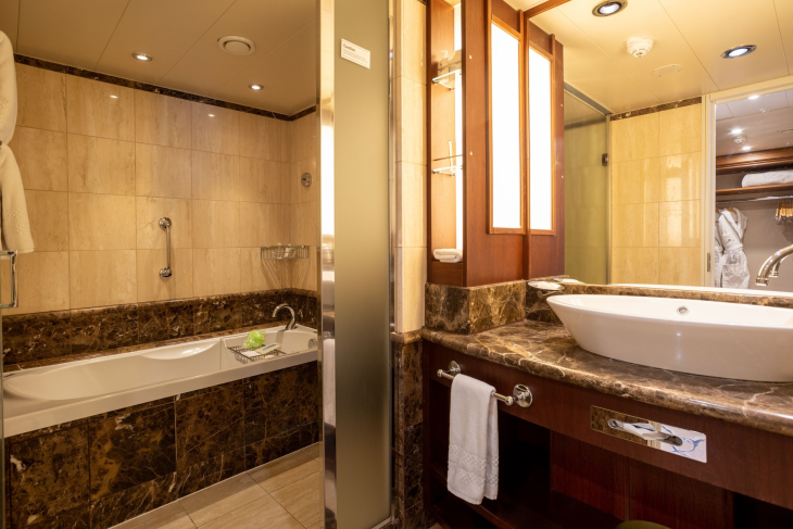 Bathtub and sink in Owners Suite bathroom on Exploris One. 