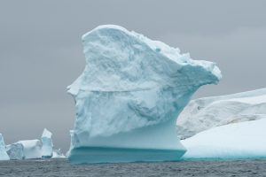 Unique iceberg rising high above the water in Antarctica. 