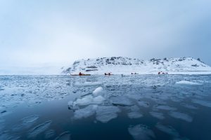 Kayakers in icy waters in Antarctica.