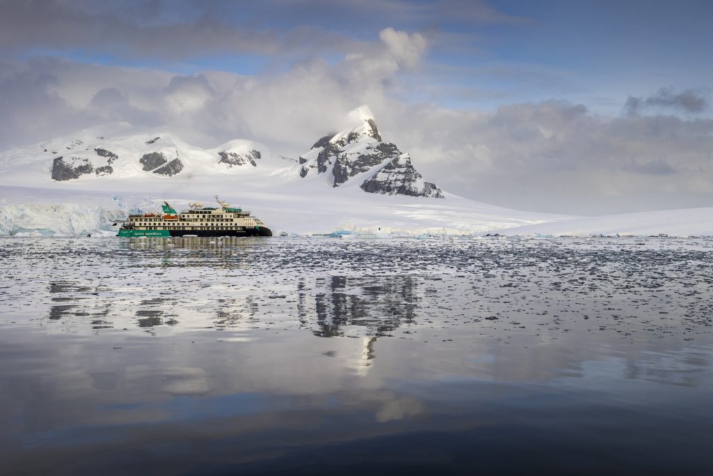 Sylvia Earle sailing with dramatic peaks in background. 