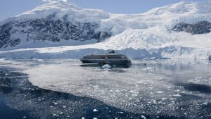 The ship World Explorer sailing in icy Antarctic waters. 