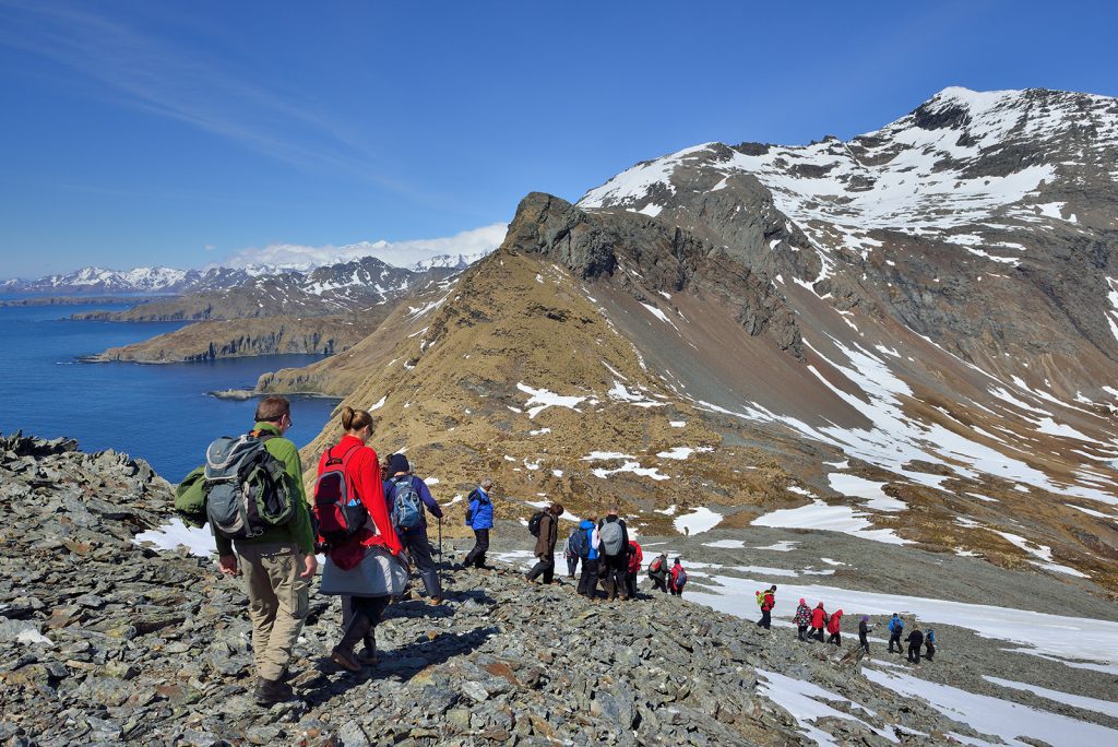 Hikers descending a mountain in South Georgia. 