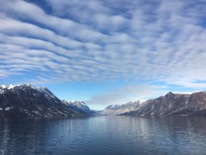Scenic fjord with blue skies in East Greenland. 