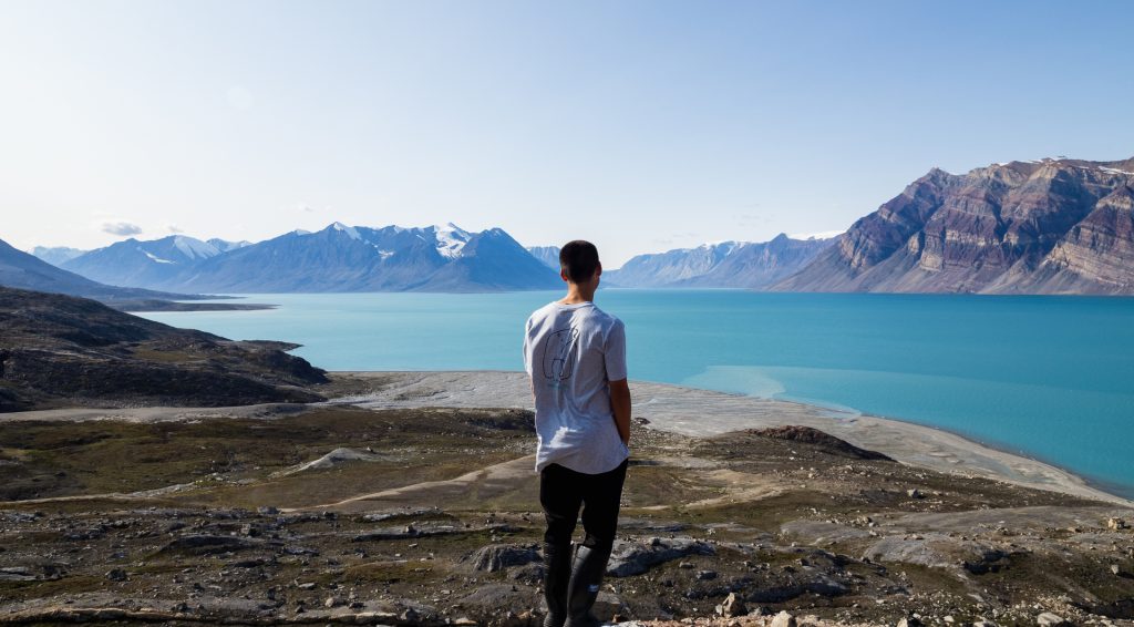 A guest gazing at scenic fjord. 