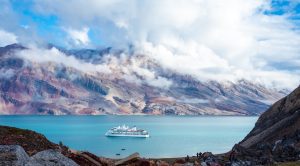 The ship Greg Mortimer in a fjord in East Greenland. 