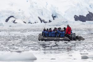 A zodiac cruising through icy waters in Antarctica.