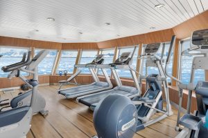 Fitness Center onboard National Geographic Explorer showing workout equipment and huge windows