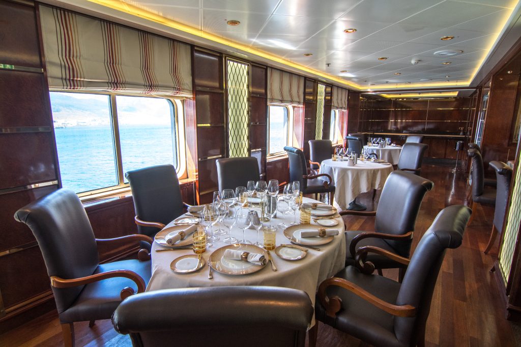 Formal dining tables & chairs in La Dame Restaurant on Silver Cloud. 