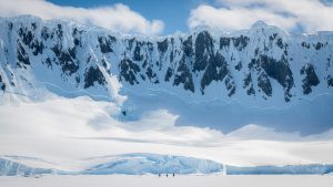 Snowy cliffs leading to sea.