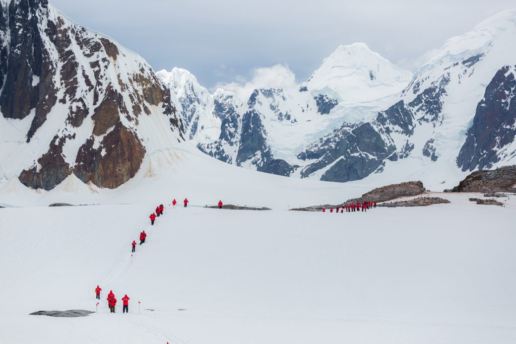 Guest walking of snowy hillside. 