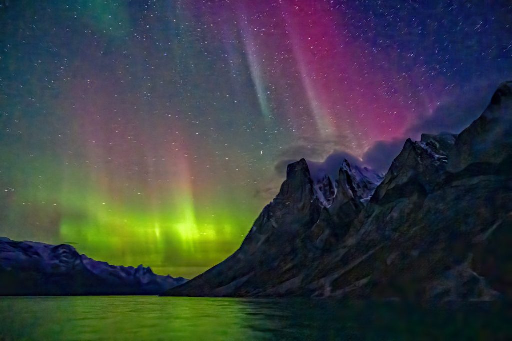 Northern lights over fjord.