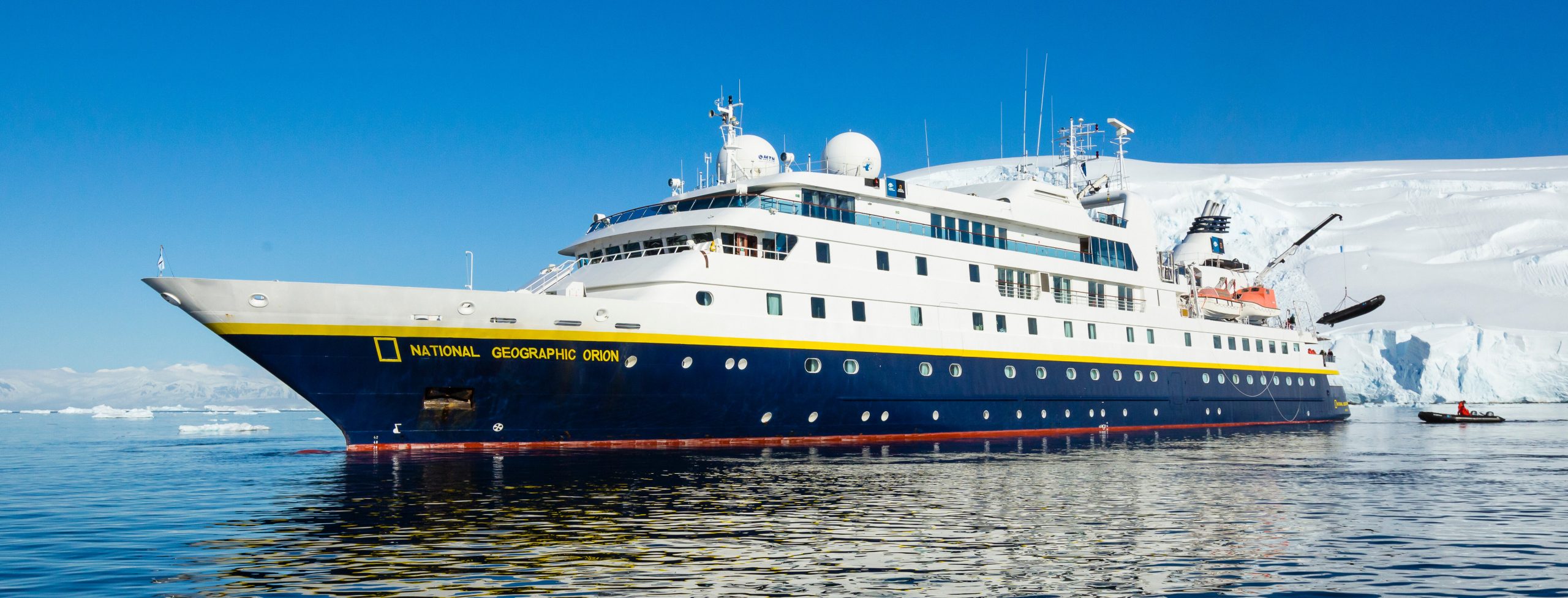 National Geographic Orion cruise ship in Antarctica with glacier in background