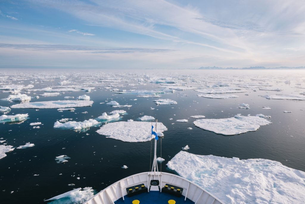 The bow of a ship sailing into pack ice. 
