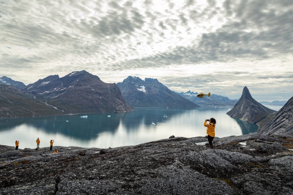Guests looking at fjord in Greenland, 