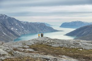 Guest hiking at the top of a fjord. 