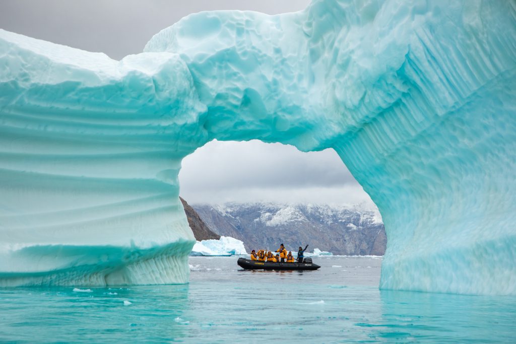 Zodiac in arch of a large iceberg.
