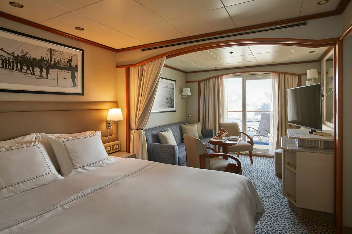 Veranda Suite on Silver Cloud with bed, couch and private balcony