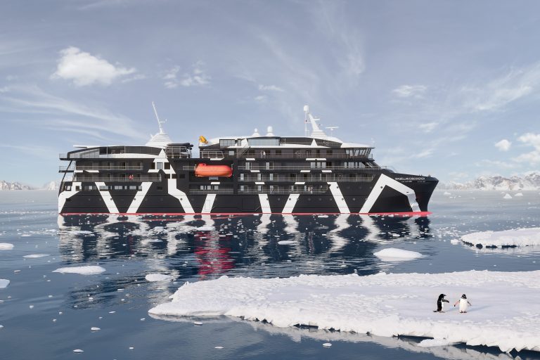 Side view of the Magellan Discoverer with an ice floe and penguins in the foreground.