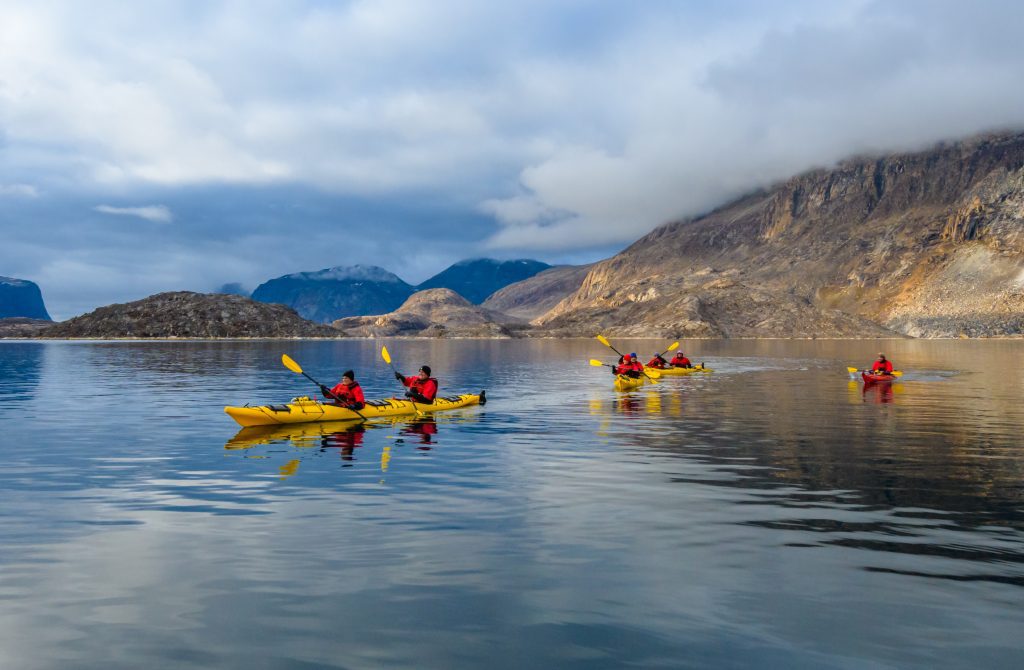 Guests kayaking in the Arctic waters.
