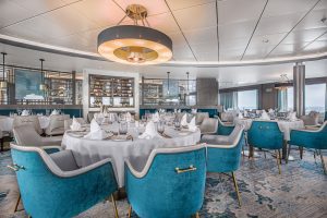 Ocean Victory Beagle Restaurant with circular tables & white tablecloths.