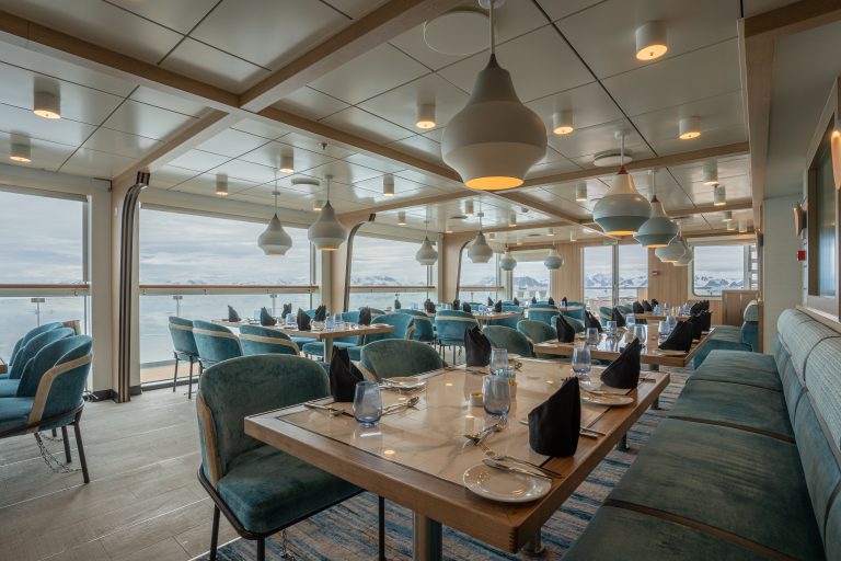 Photo of specialty restaurant with large table and huge windows.