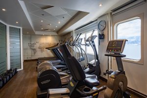 Discoverer Fitness Center with treadmills, ellipticals and free weights. Three large windows with ocean views.