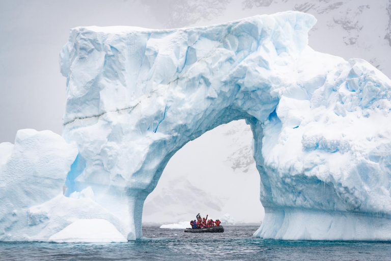 Huge iceberg with arch and zodiac.