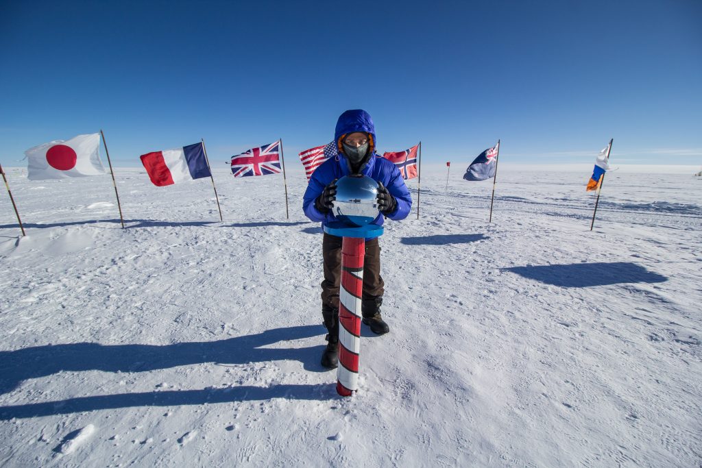 Guest holds onto the silver ball atop the Cerermonial South Pole