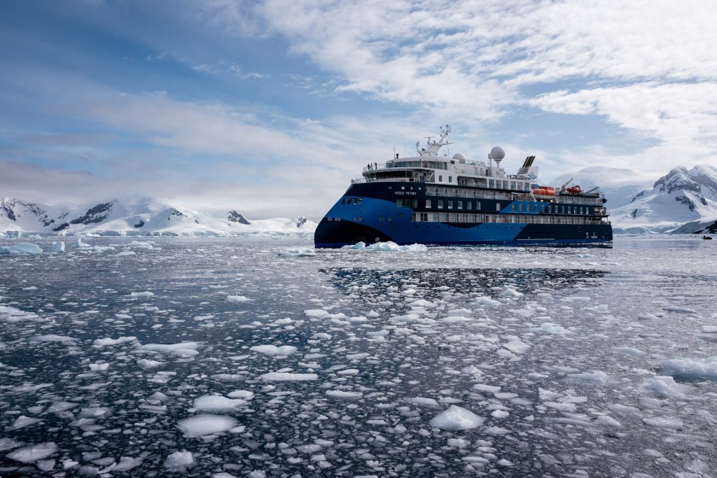 The ship Ocean Victory anchored in icy water in Antarctica.