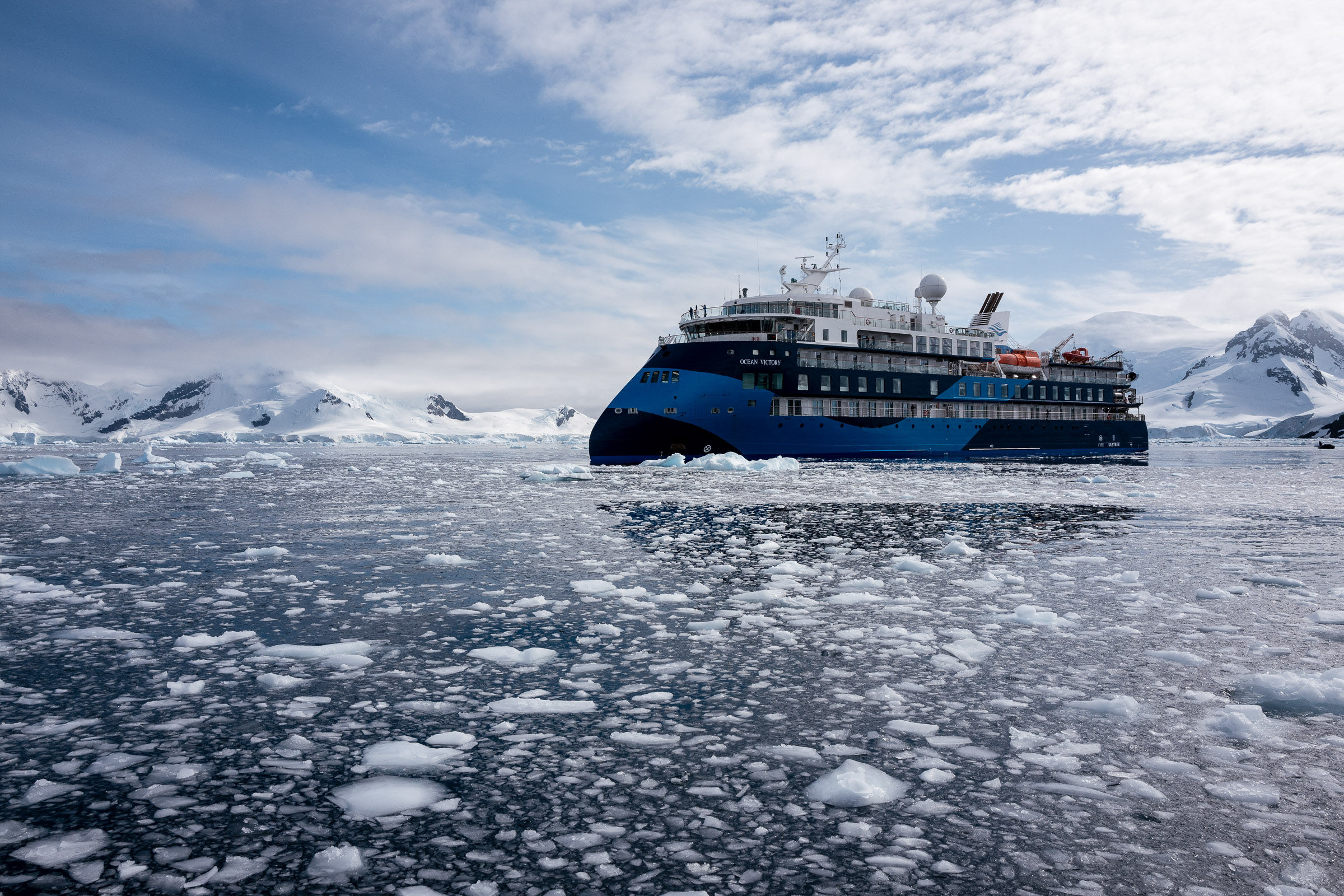 The ship Ocean Victory anchored in icy water in Antarctica.