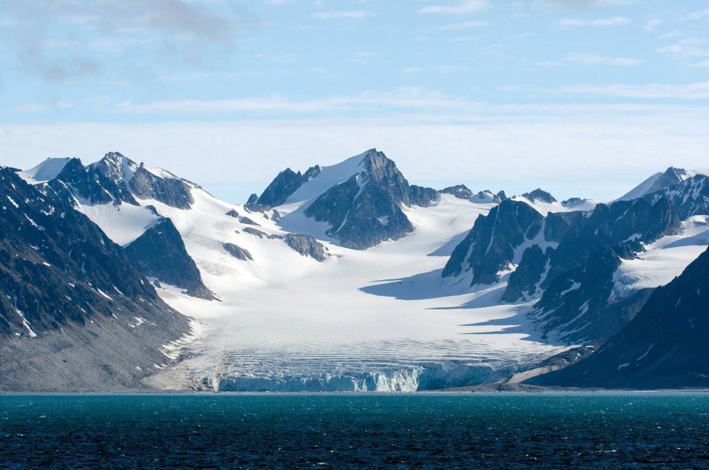 A mountain scene with large glacier taken from the water. 