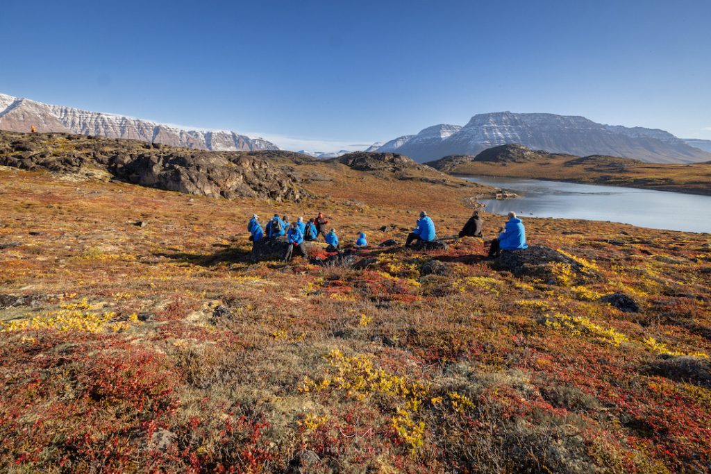 Guest sitting on colorful tundra. 