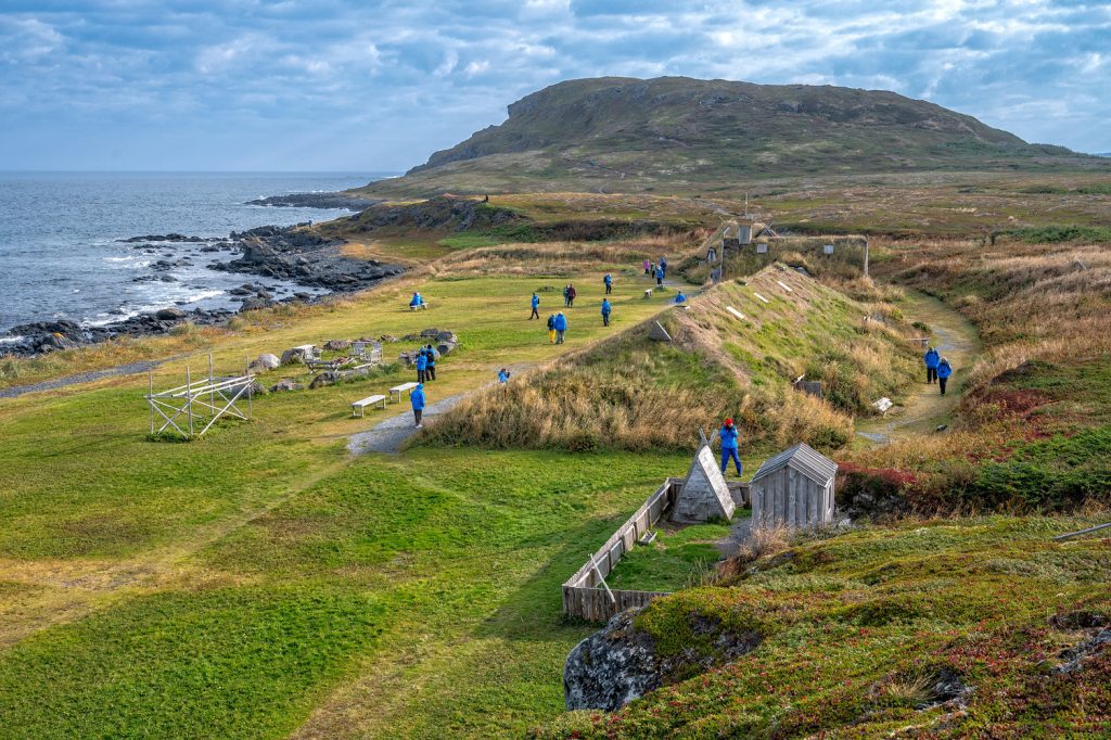 Guests hiking the green shoreline.
