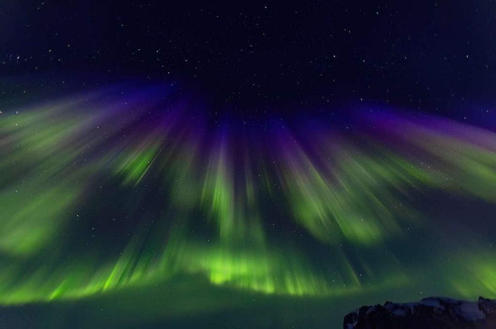 Beautiful northern lights in green & purple color.