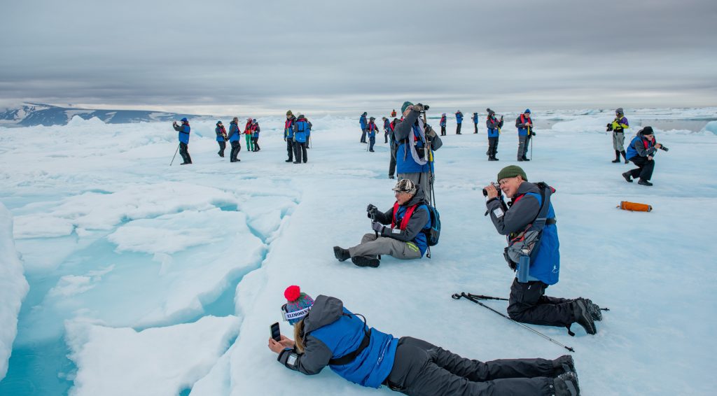 Guests taking photographs on the sea ice.