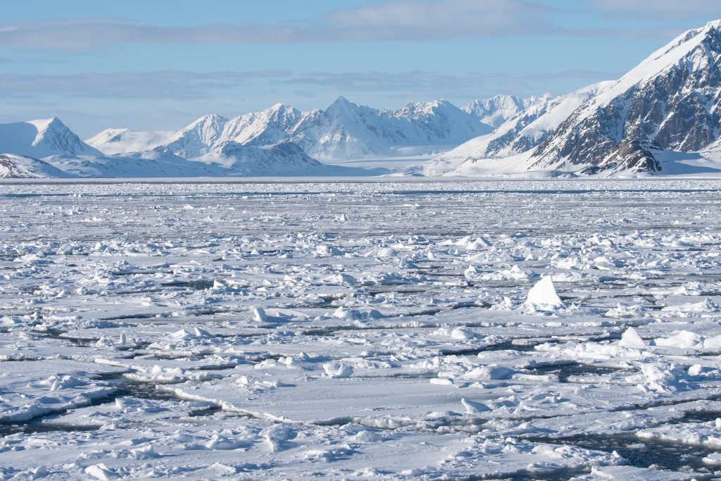 A fjord covered in sea ice in Svalbard. 