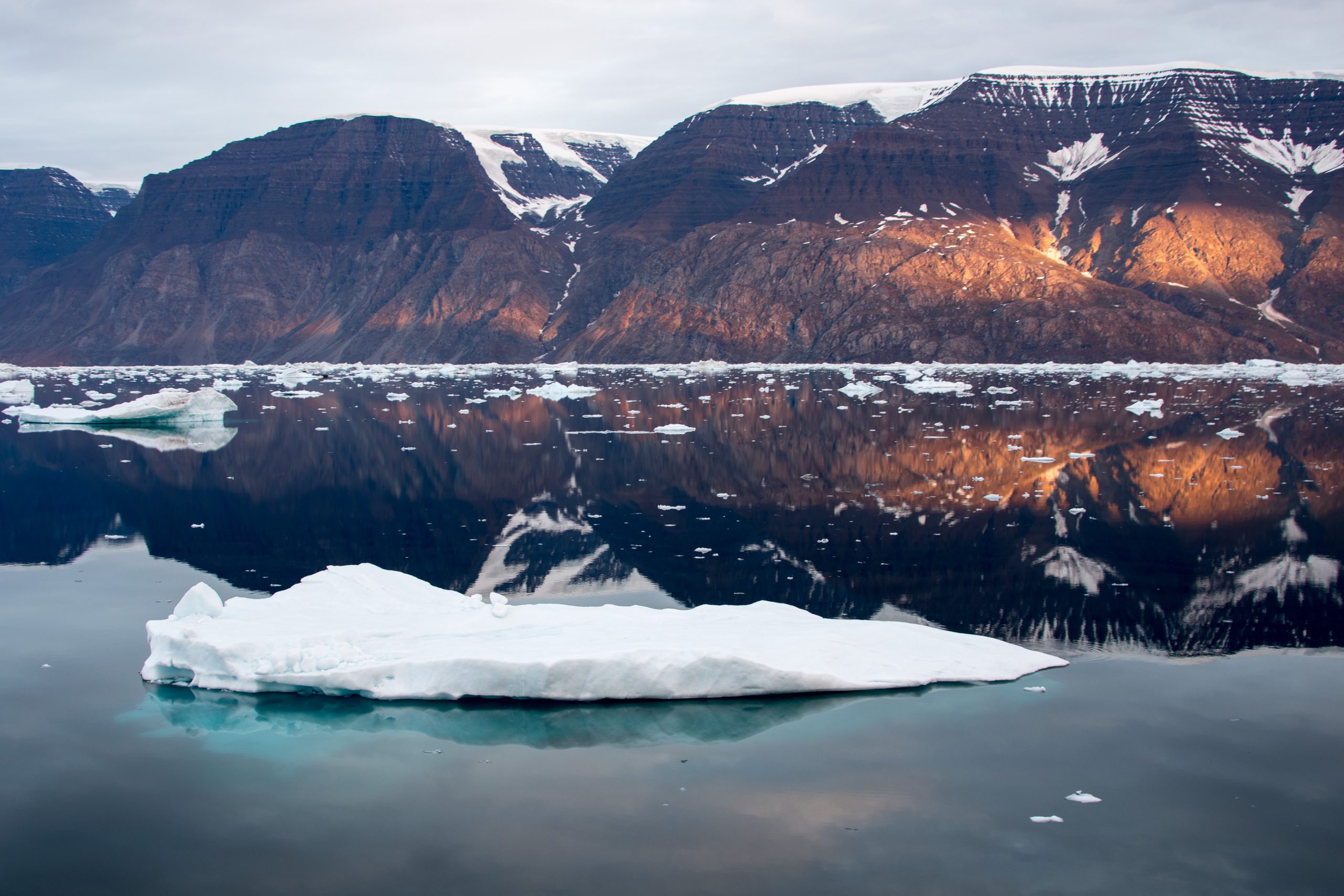 A scenic fjord at sunrise in East Greenland.