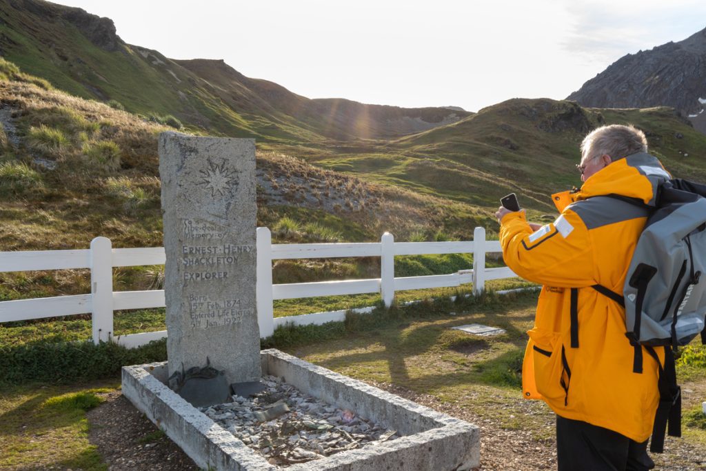 Guest talking a photo of Shackleton's grave at Grytviken, South Georgia. 