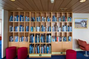 Wall bookcase in the library on Ocean Nova. 