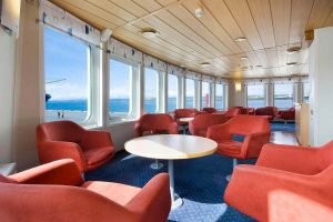 Red chairs and big windows in aft lounge of Ocean Nova. 