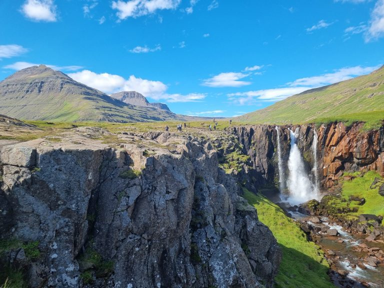 Waterfall with blue skies in Iceland.